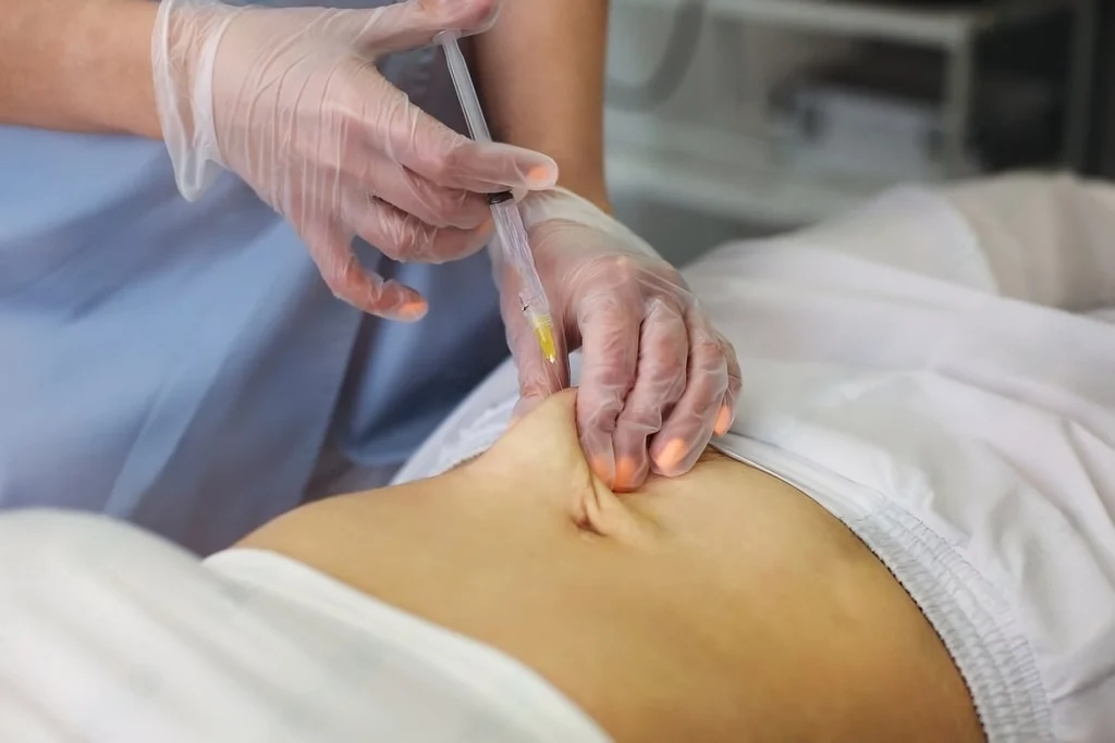 a person injecting a stomach