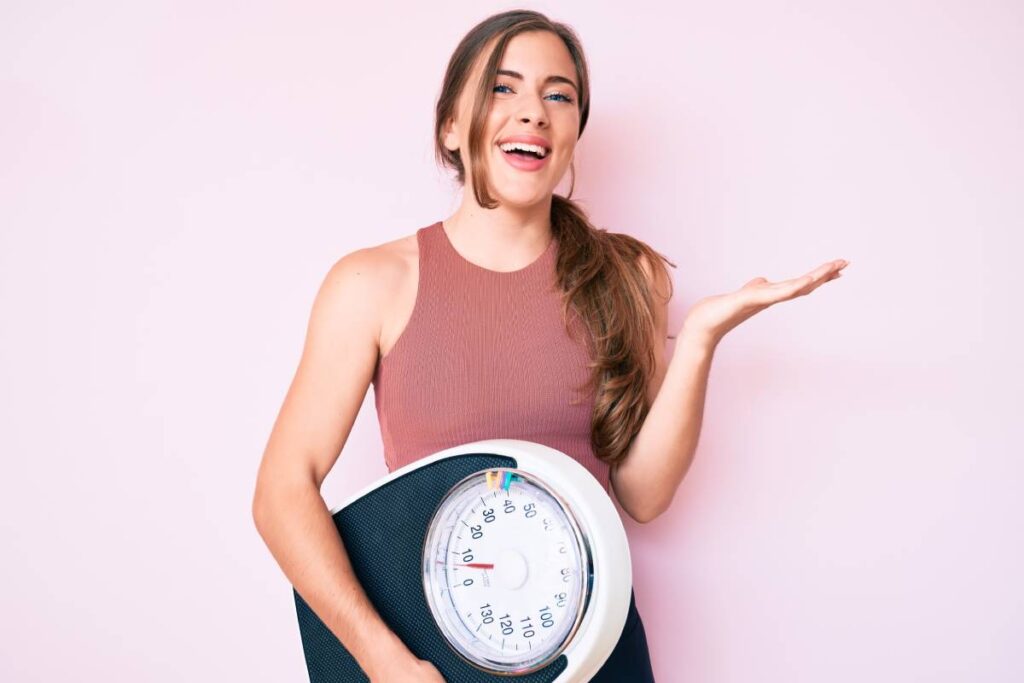 a woman holding a scale
