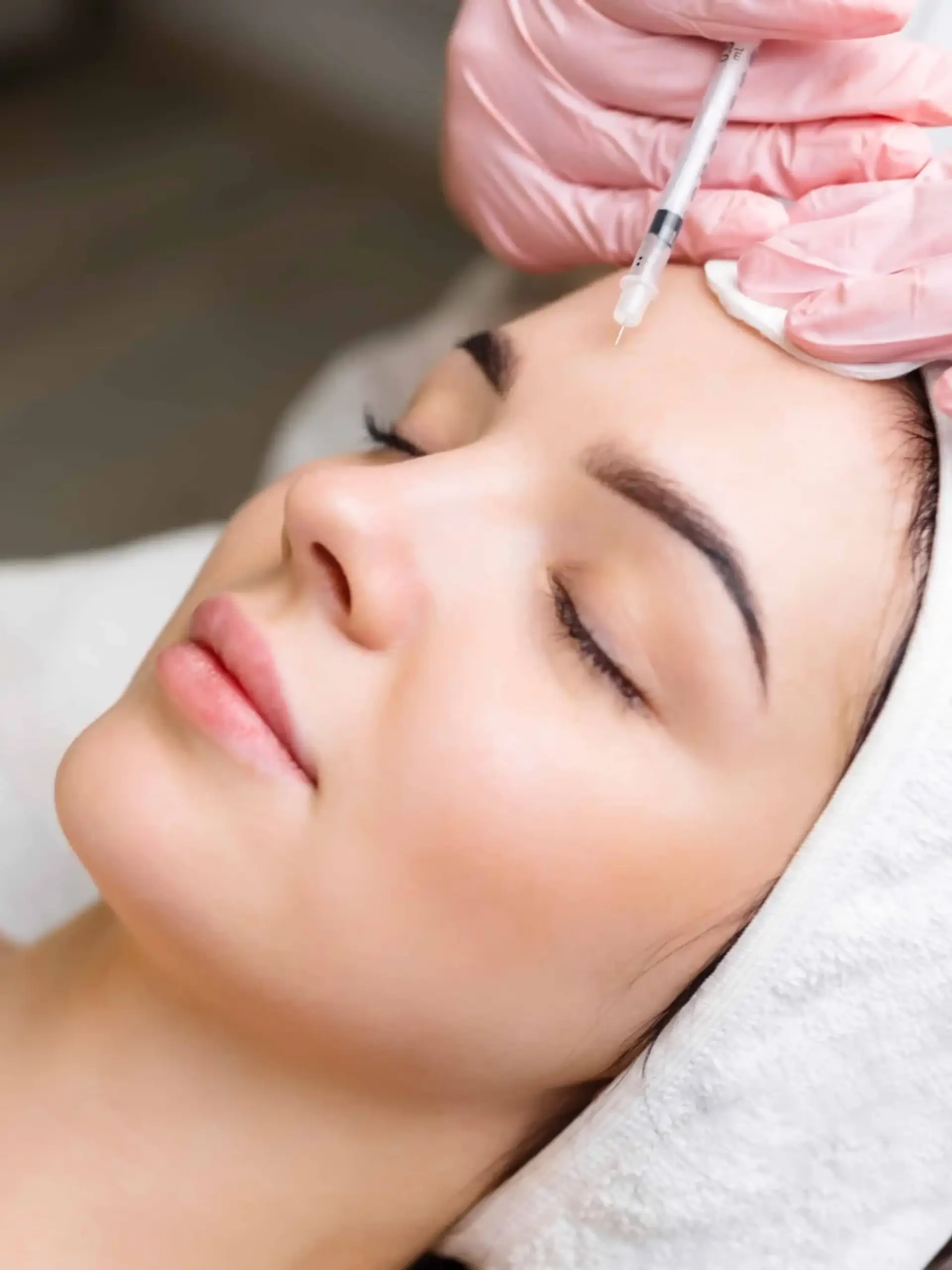 a woman receiving a botox injection